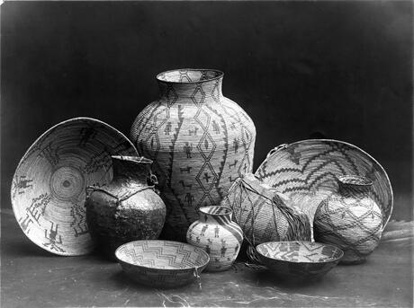 Apache basketry of yucca, willow or juniper. Edward Curtis print 1907. See https://commons.wikimedia.org/wiki/File:Apache-still-life_restored.jpg